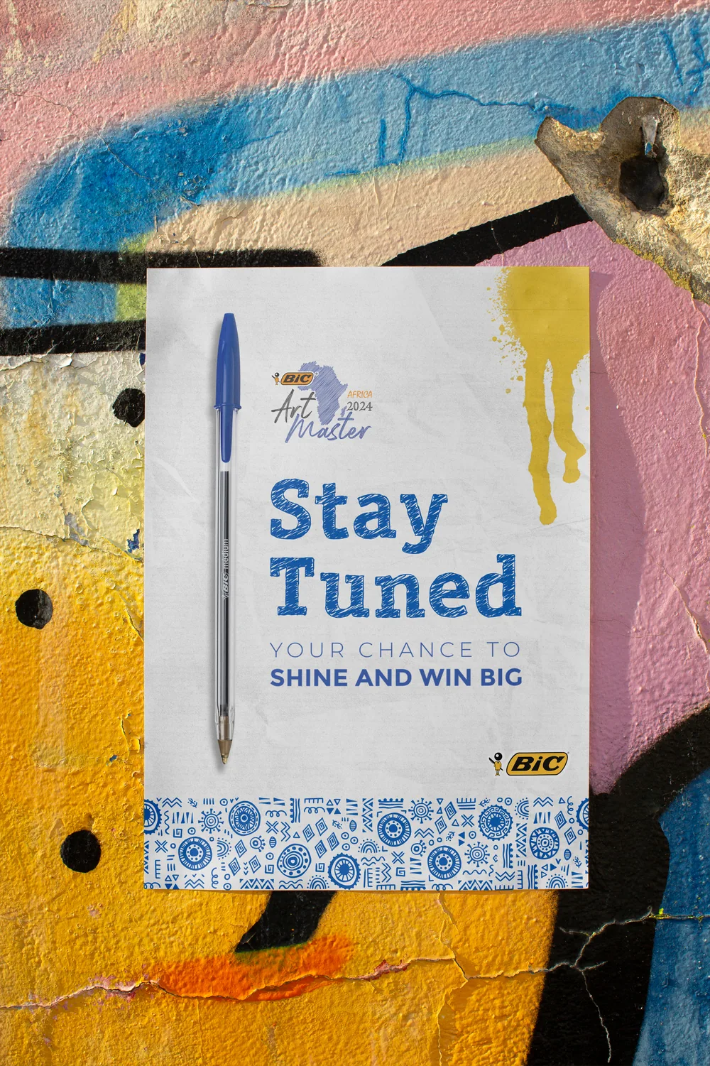 BIC Art Master Africa 2024 Stay Tuned poster on a graffiti wall