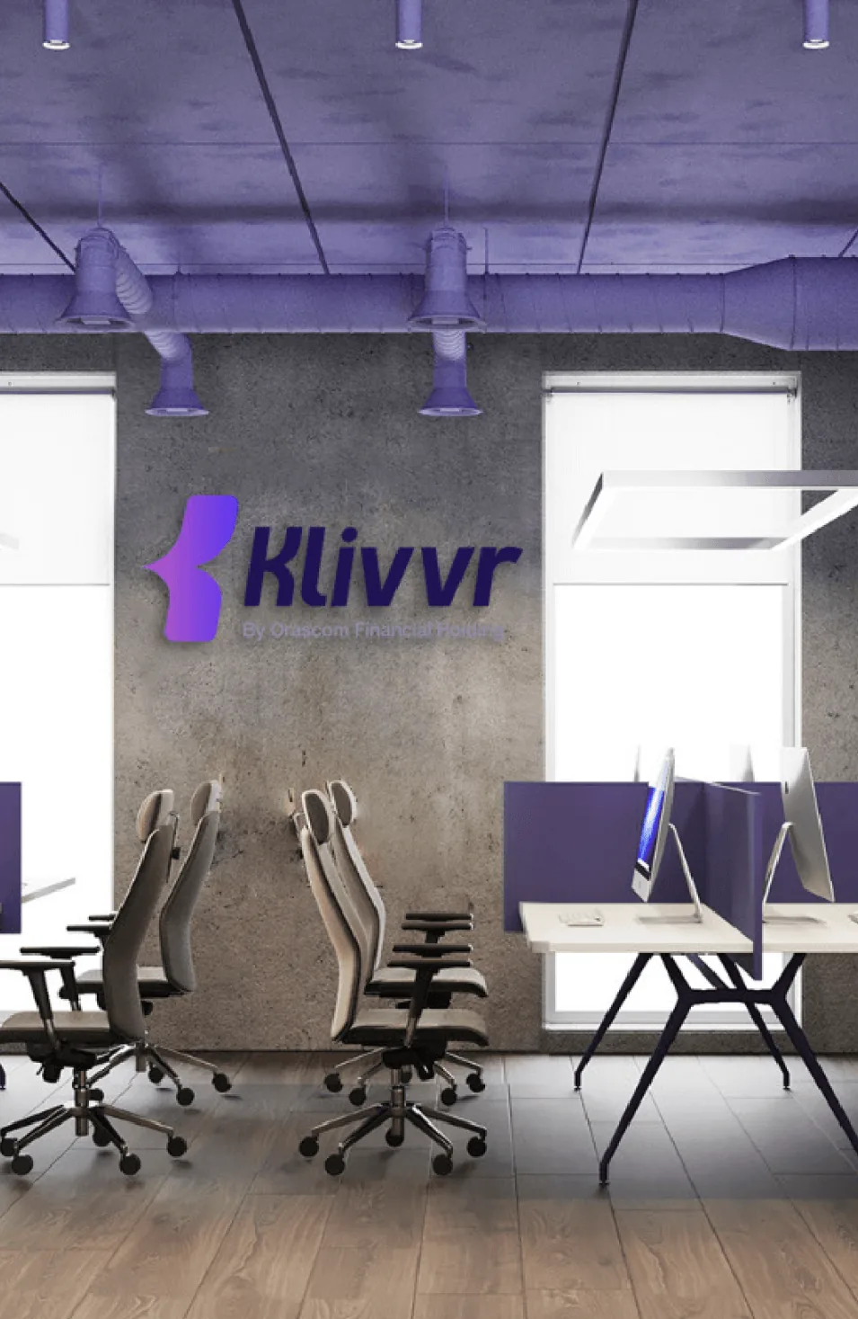 Klivvr wordmark applied as office signage above a row of workstations