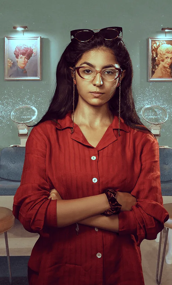 Woman in a red shirt with retro sunglasses and cat-eye glasses